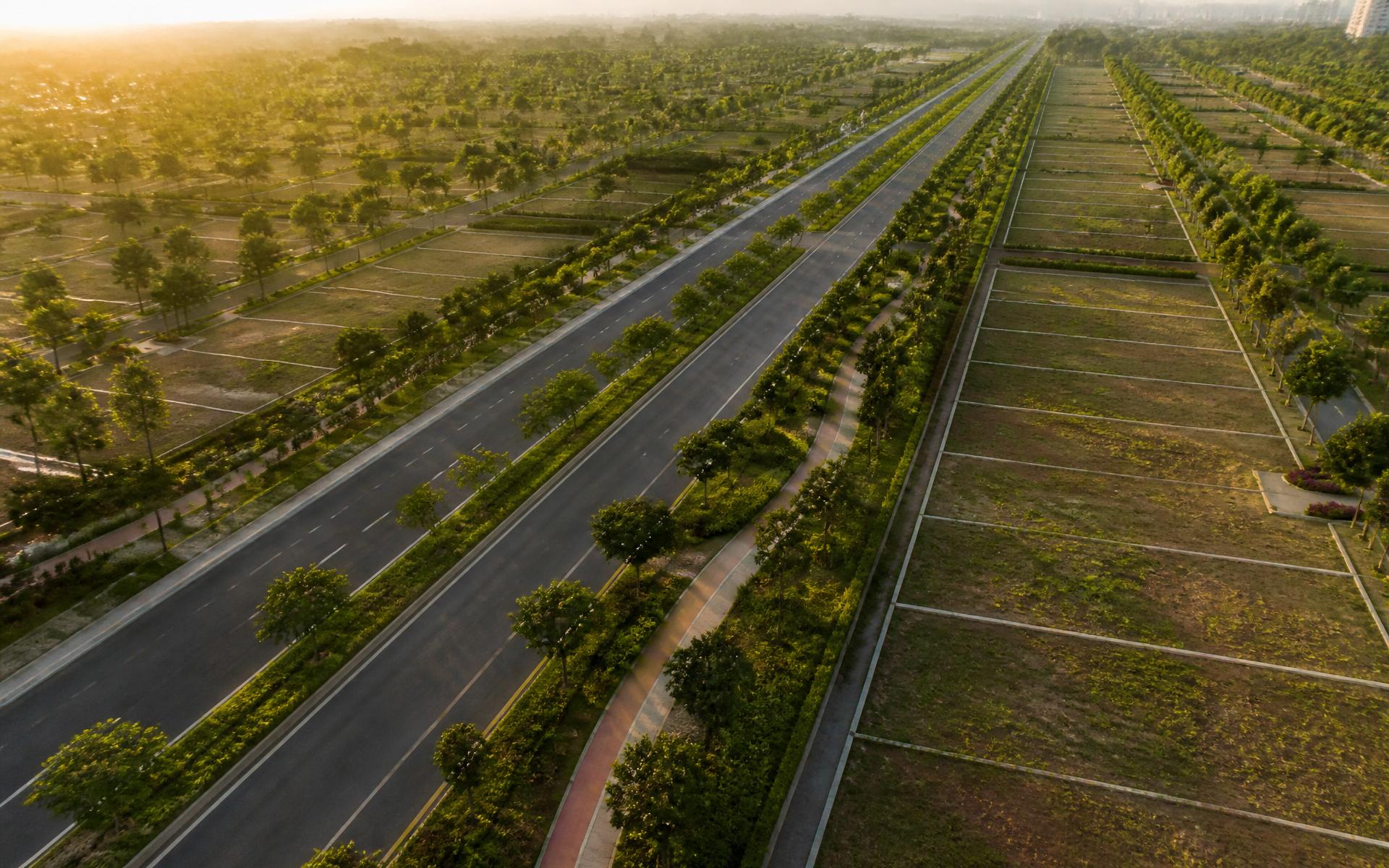 Tree-lined boulevards inside a premium township, aerial view